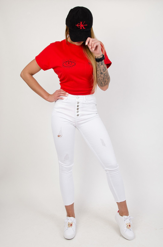 Białe spodnie jeansowe z przetarciami zapinane na guziki