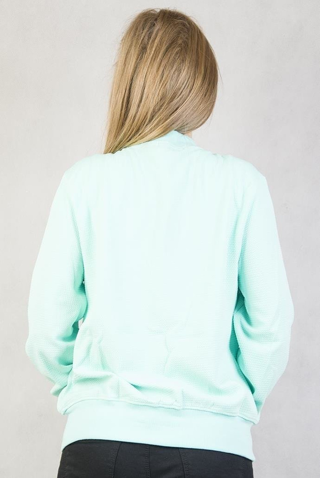 Zielona bluza z napisem "Good girls gone bad"