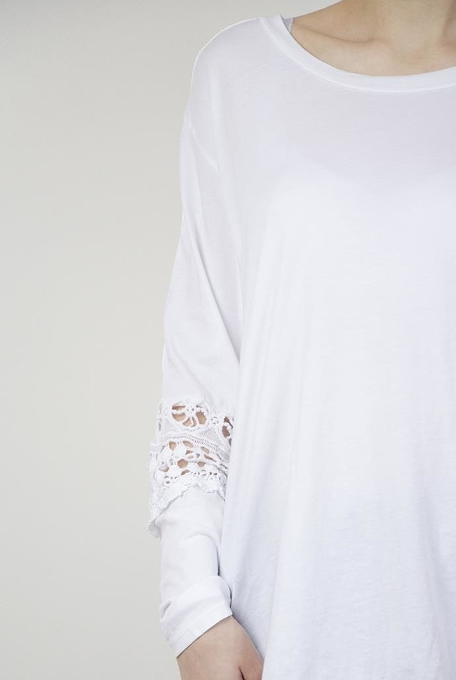 Biała bluzka z pięknymi zdobieniami na ramionach