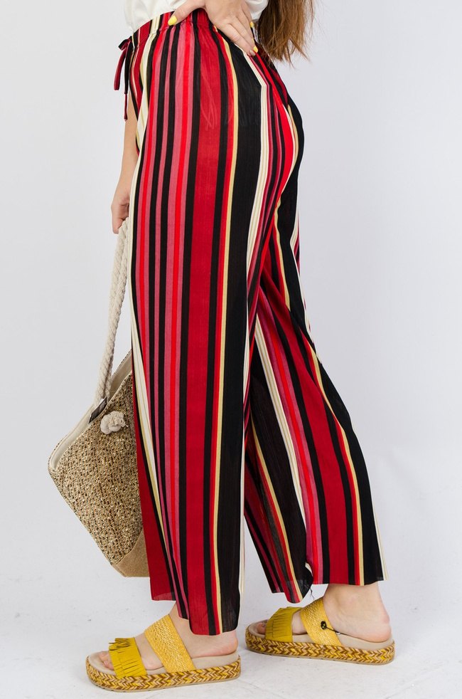 Kolorowe spodnie w paski z rozszerzanymi nogawkami