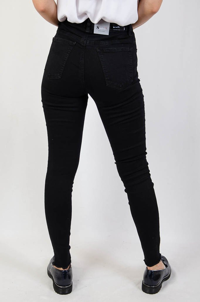 Czarne jeansowe spodnie z przetarciami oraz szarpaniem na dole nogawki