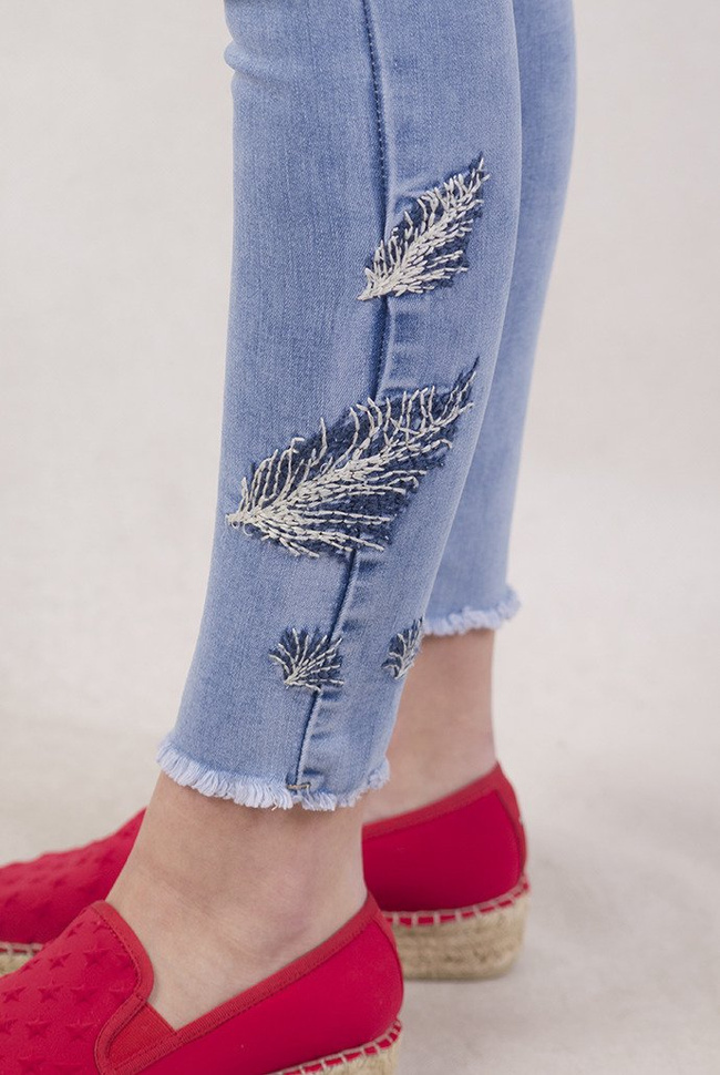 Jasne spodnie jeansowe z wyszywanymi piórkami