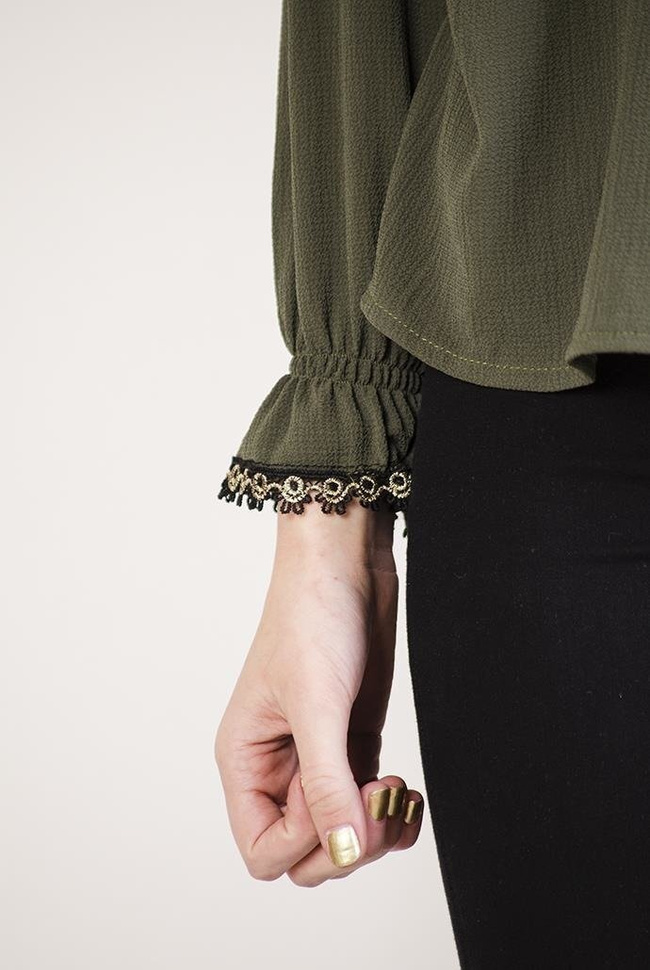 Zielona bluzka z falbanką i wiązaniem przy szyi