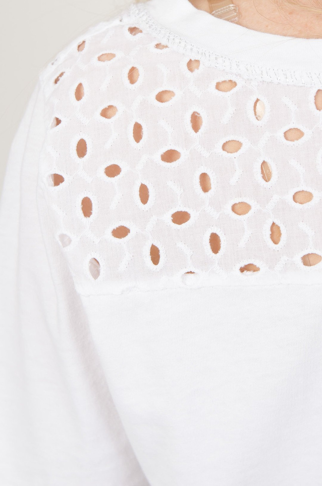 Biała bluzka obszyta srebrną nicią i ażurową kieszonką 