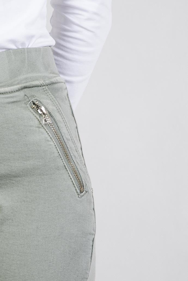 Zielone spodnie z zamkami i gumą w pasie