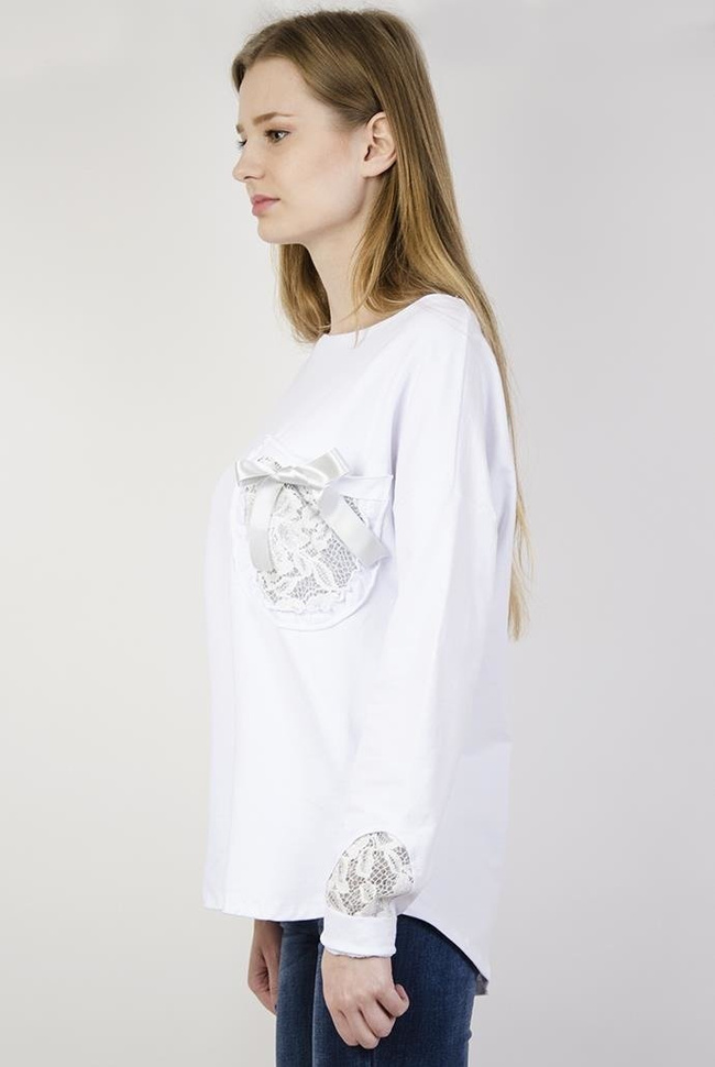 Biała bluzka z kokardką przy kieszonce i zdobieniami przy rękawach