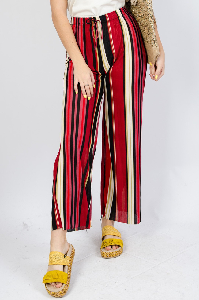 Kolorowe spodnie w paski z rozszerzanymi nogawkami