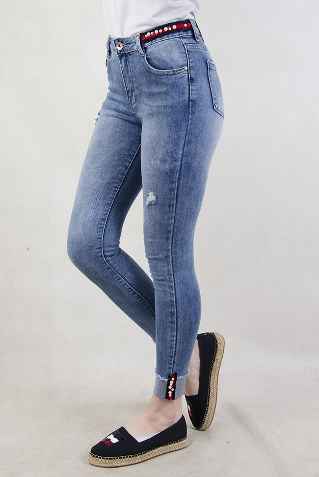 Spodnie jeansowe z ozdobami oraz wywinięta nogawką