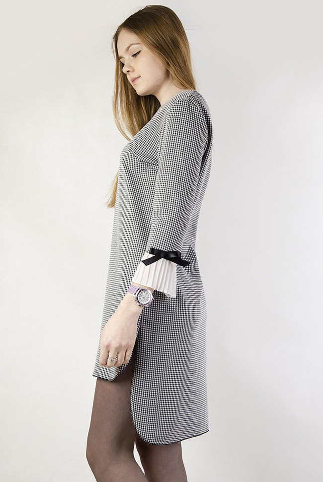 Asymetryczna sukienka w pepitkę z plisowaniem przy rękawie.