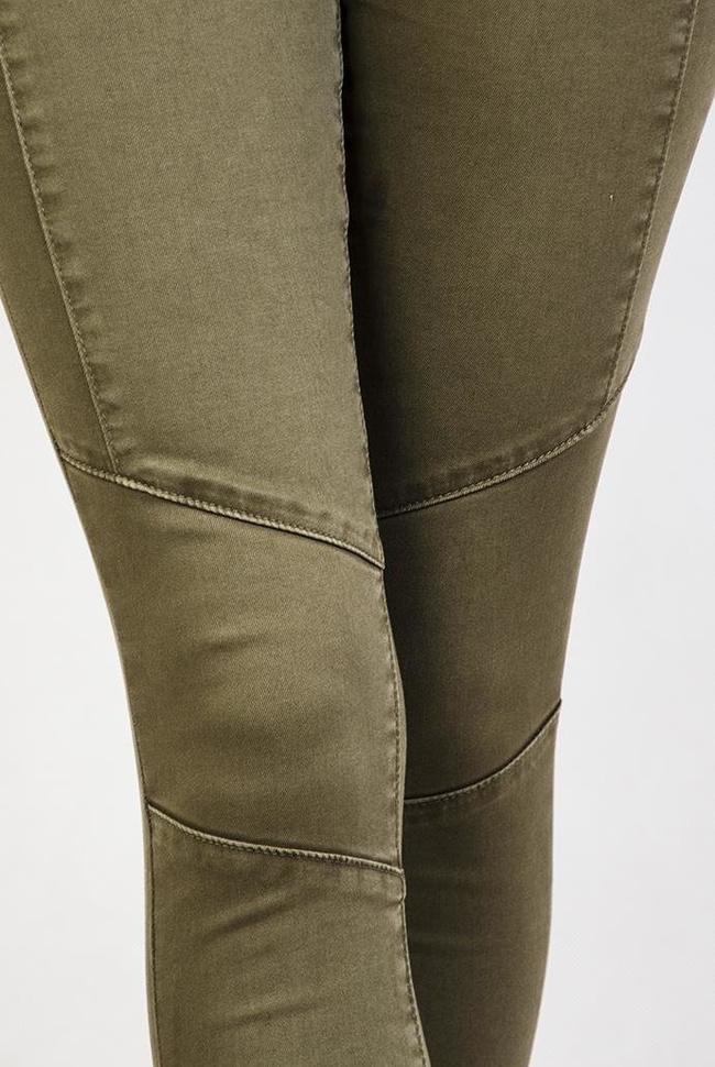 Zielone spodnie rurki jeansowe z zamkami i przeszyciami