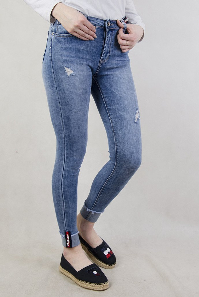 Spodnie jeansowe z ozdobami oraz wywinięta nogawką