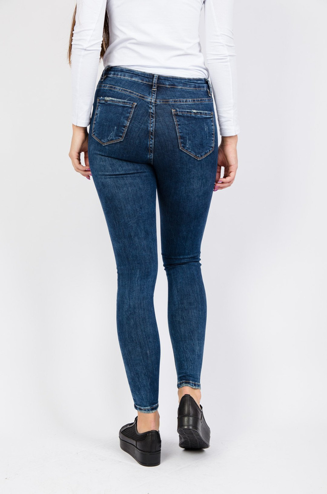 Ciemne spodnie jeansowe z przetarciami