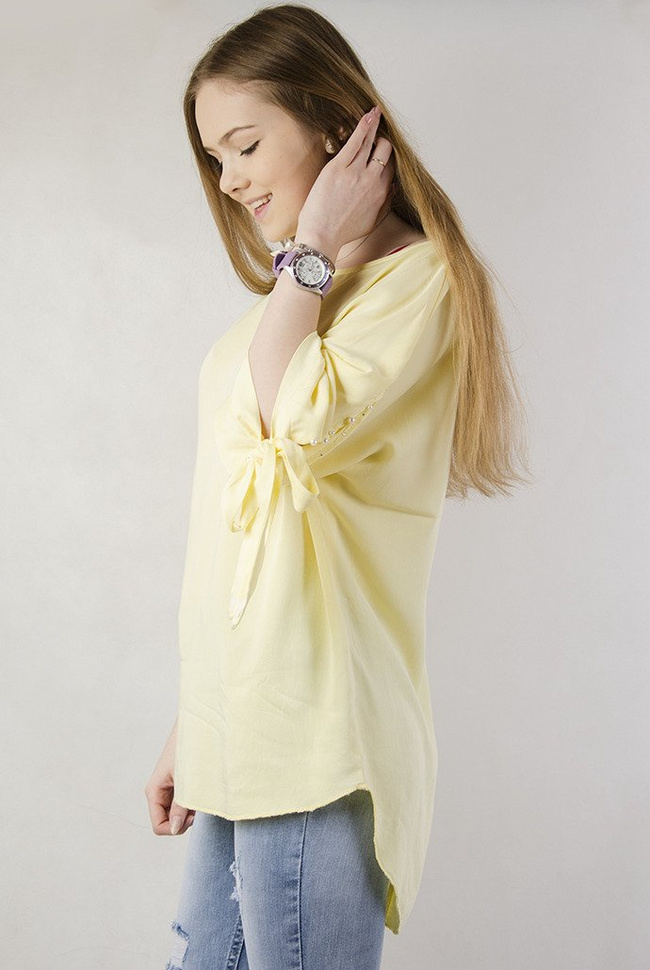 Żółta asymetryczna bluzka z wiązaniem przy rękawie oraz perełkami