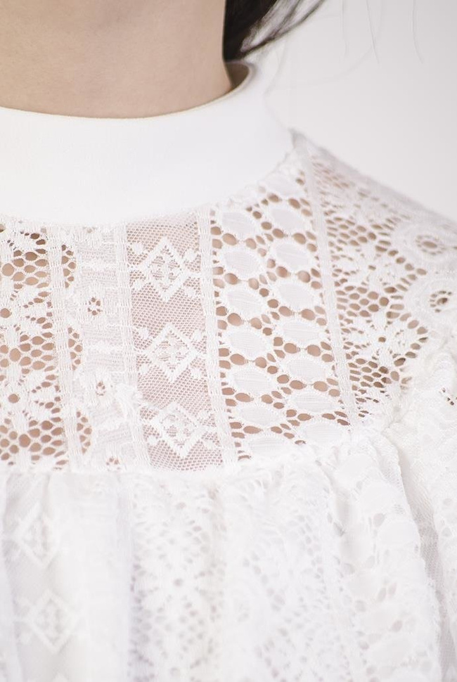 Biała bluzka z ażurowymi wstawkami i falbanką przy dekolcie