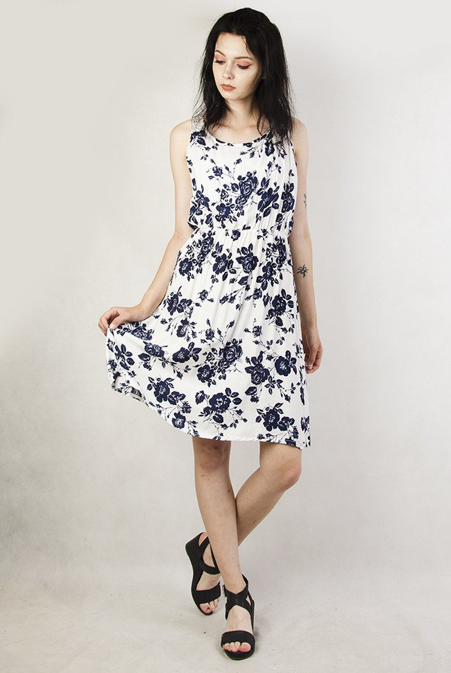 Biała sukienka w granatowe kwiaty z zamkiem z tyłu, zakończonym perłą.