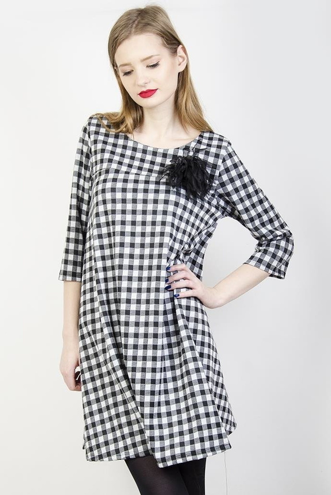 Rozkloszowana biało-czarna sukienka w kratę z broszką