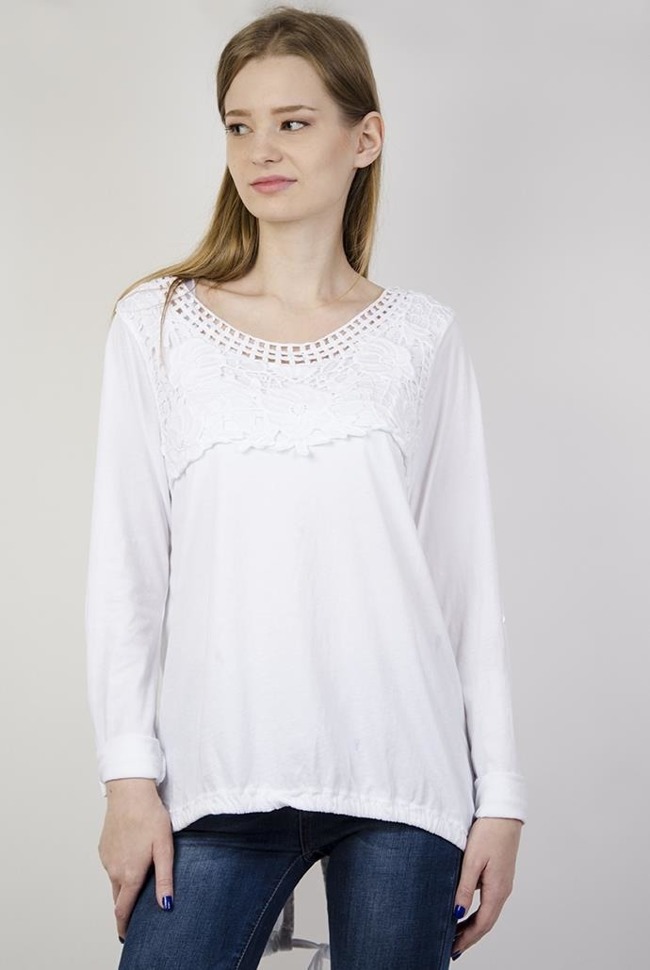 Biała bluzka z ażurowymi zdobieniami przy dekolcie oraz ze ściągaczem na dole