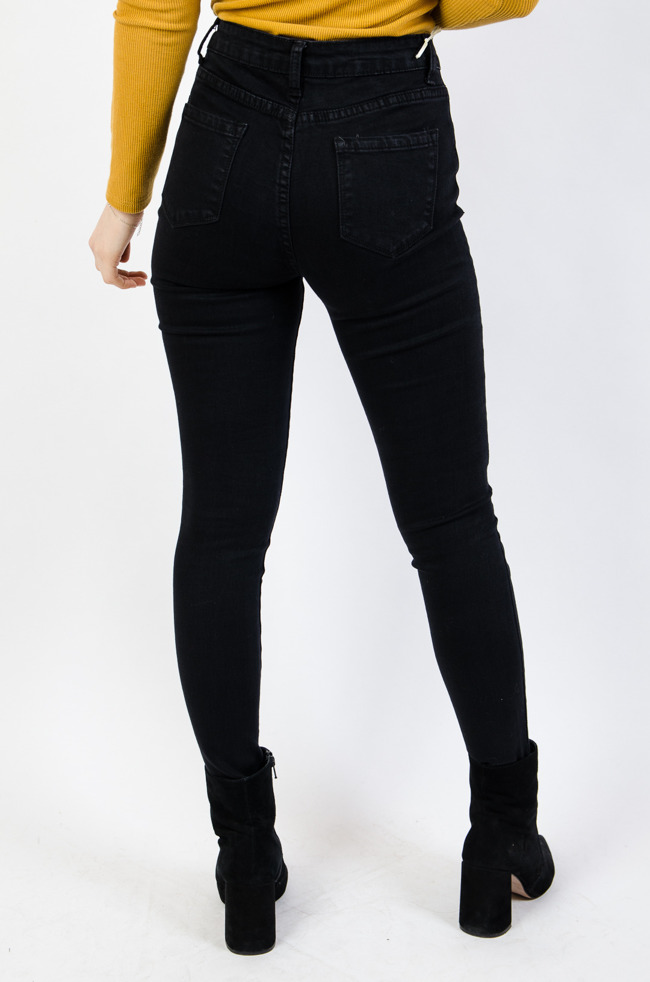 Czarne spodnie jeansowe z czterema srebrnymi guzikami na przodzie