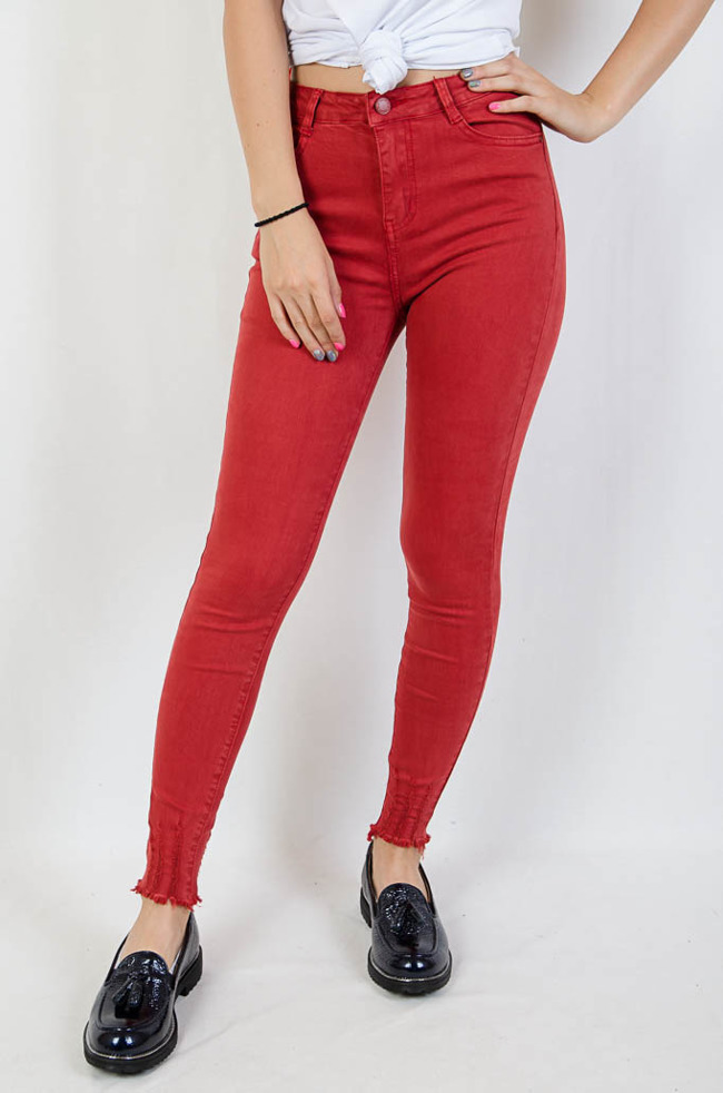 Czerwone spodnie jeansowe z szarpaniami na dole nogawki