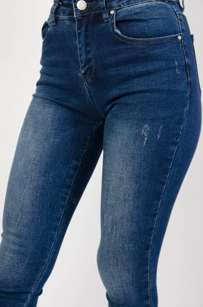 Spodnie jeansowe z delikatnymi przetarciami i szarpaniami na nogawkach